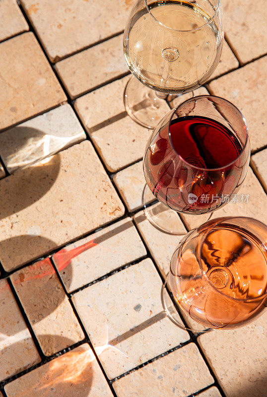 Wine glass variety with red, white and rosé wine at vineyard wine tasting in sunlight